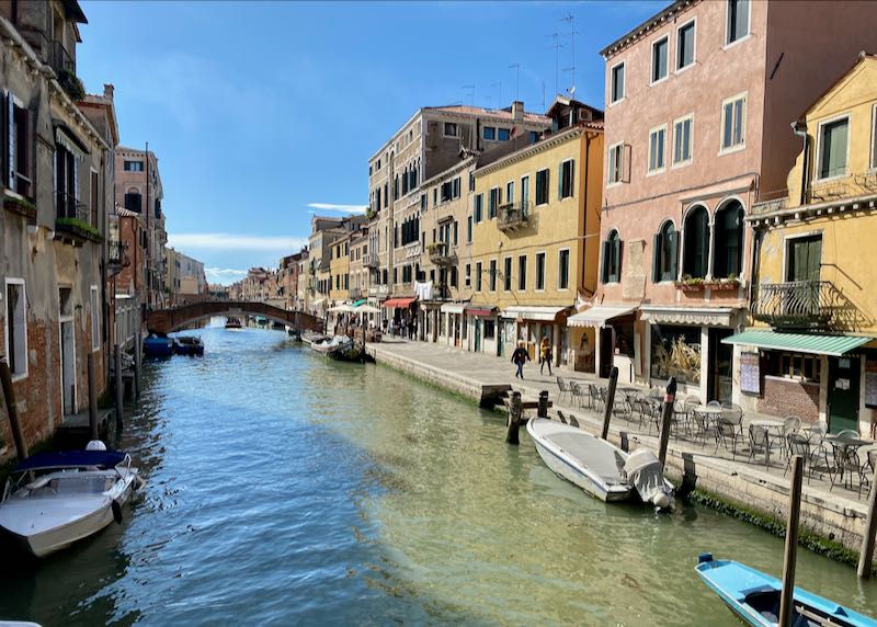 A wide Venetian canal on a sunny afternoon