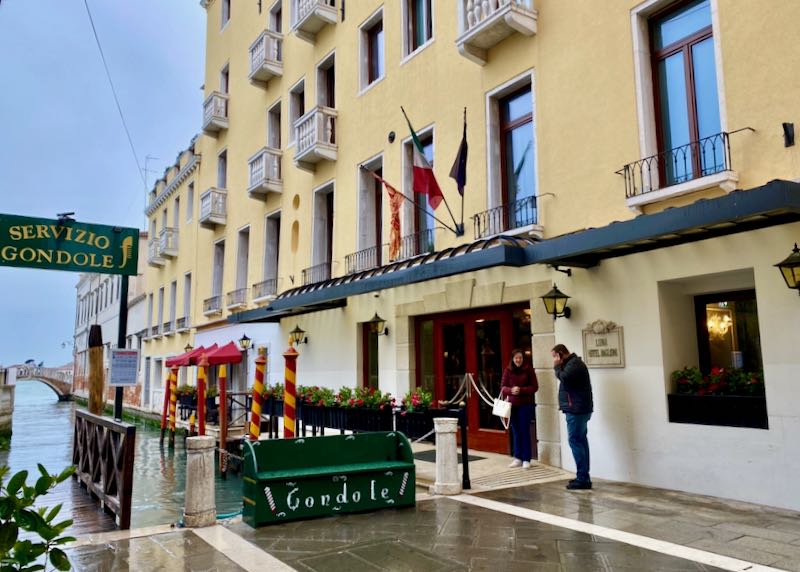 Exterior of a hotel in Venice, set on a canal with a gondola station in front