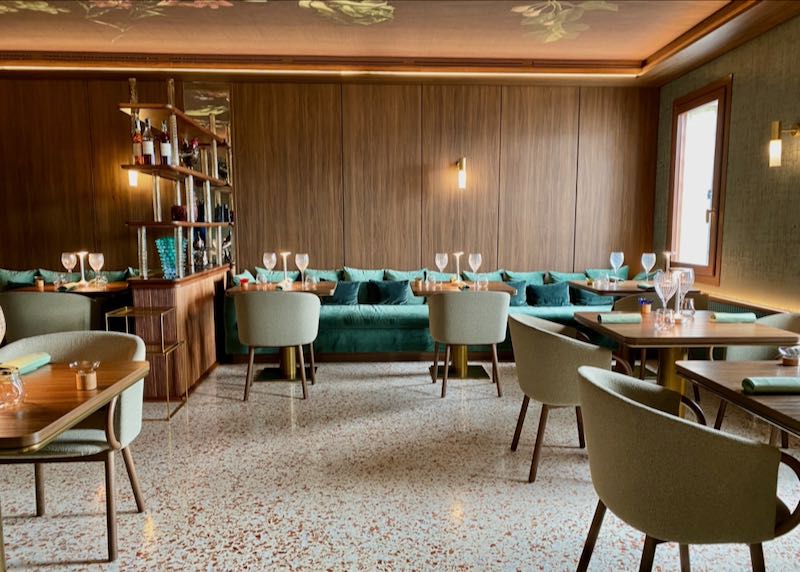 Stylish hotel breakfast room with velvet seating and terrazzo floors
