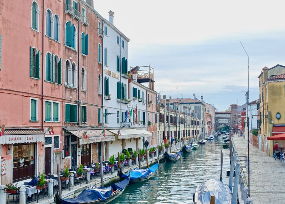Gondolas and small cafes line a canal in Venice 