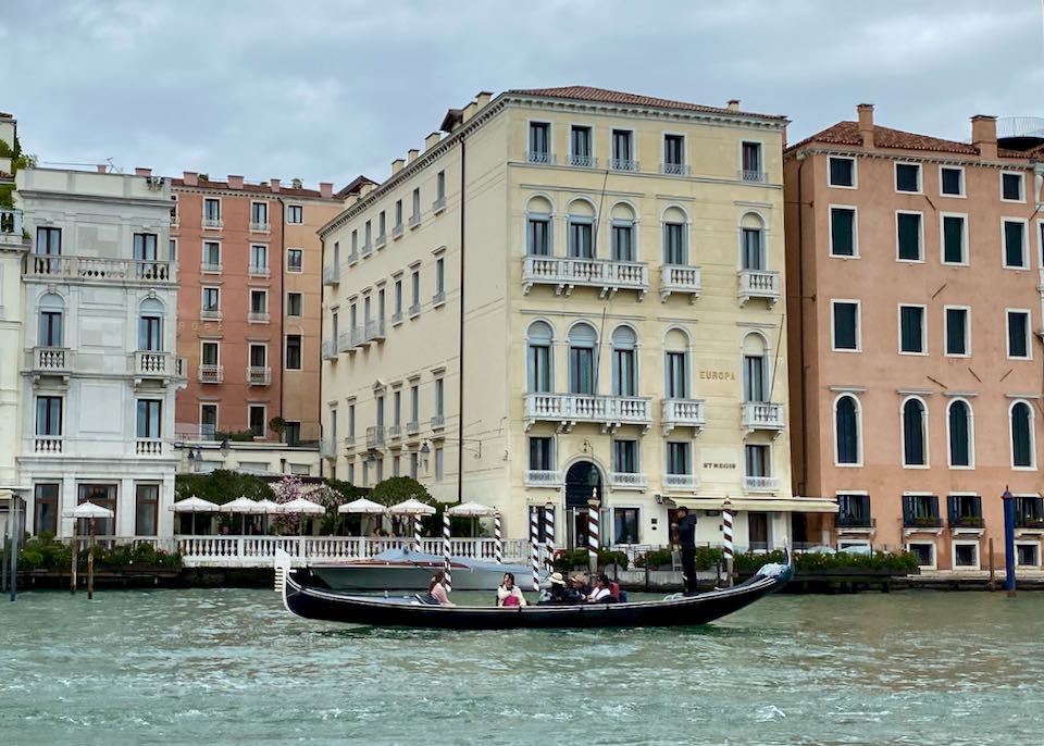 Luxury waterfront hotel in Venice, with a gondola passing in front 