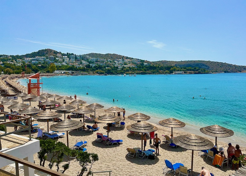 Vouliagmeni Beach with sunbeds and umbrellas in the Athens Riviera