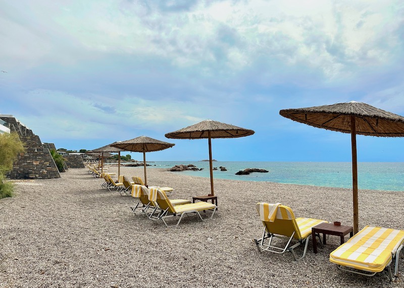 A sandy beach with unbrella and sunbed sets at the Grand Resort Lagonissi on the Athens Riviera