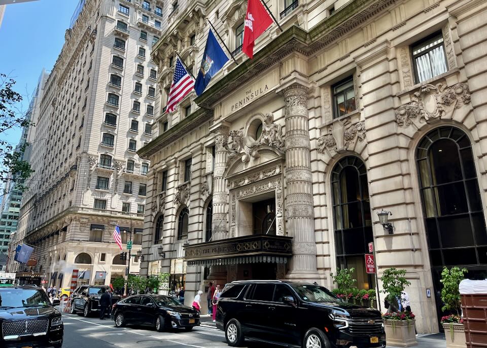 Ornate exterior of a hotel in downtown NYC, with flags flying
