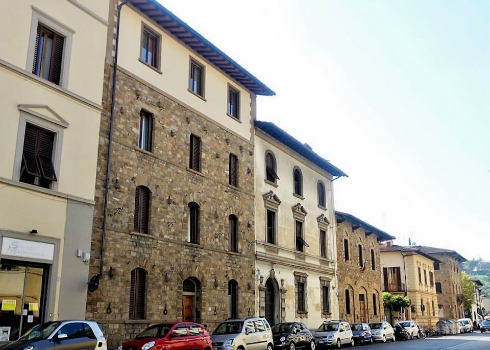 Old Florentine-style stone buildings in a row along a street