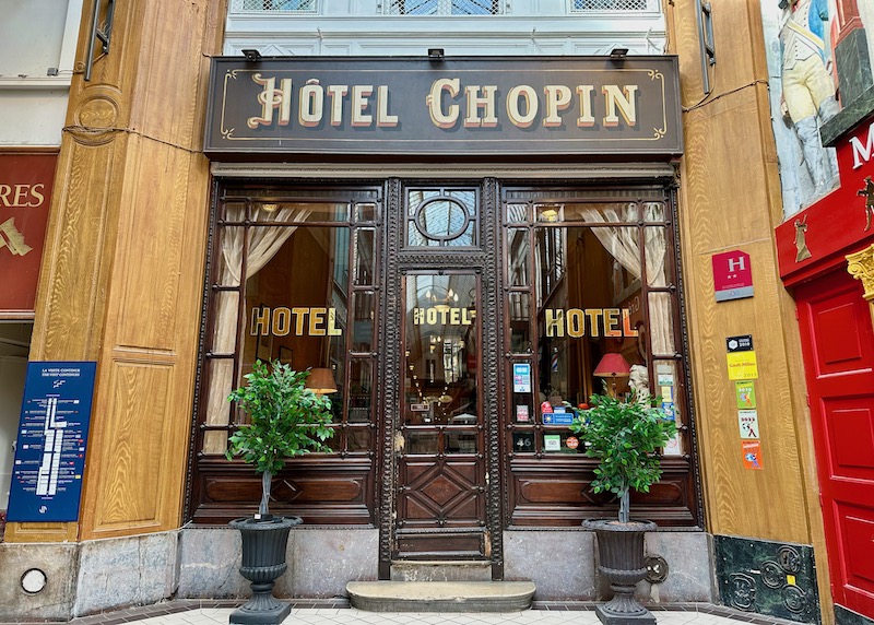 The rich wood and glass exterior of 19th-century Hotel Chopin, inside the covered Passage Jouffroy in Paris