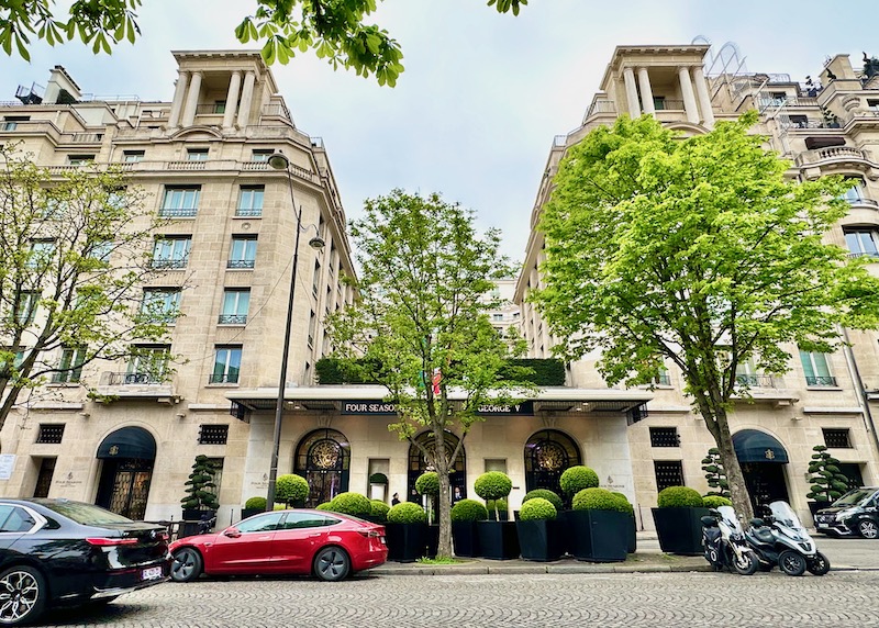Exterior of the Four Seasons George V with trees and topiary in Paris