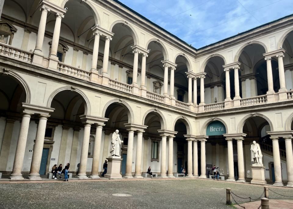 Exterior museum courtyard, lined with arched marble columns 