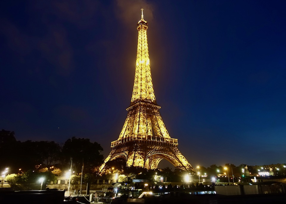 Nighttime view of the Eiffel Tower with lights