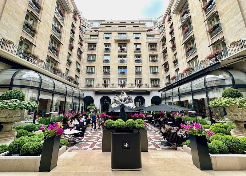 The dining courtyard in full bloom with three restaurants at the Four Seasons George V in Paris
