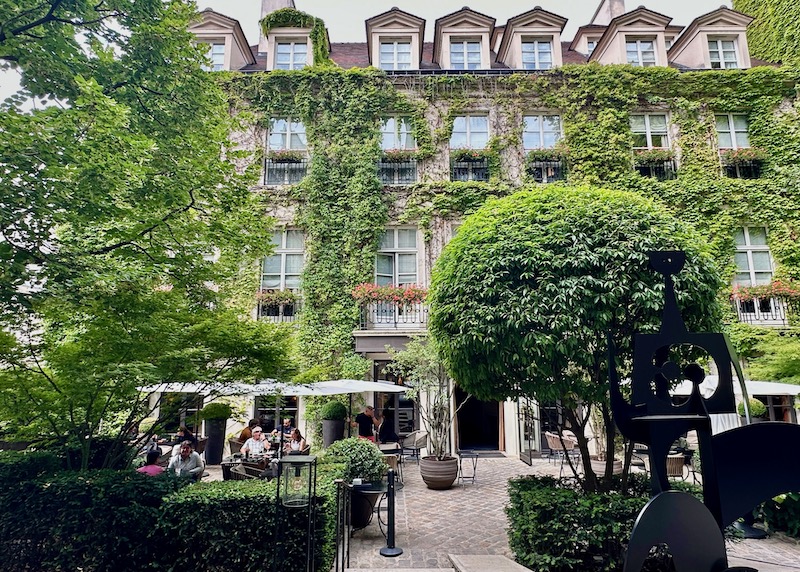 Ivy-covered exterior of Pavillon de la Reine hotel in Paris