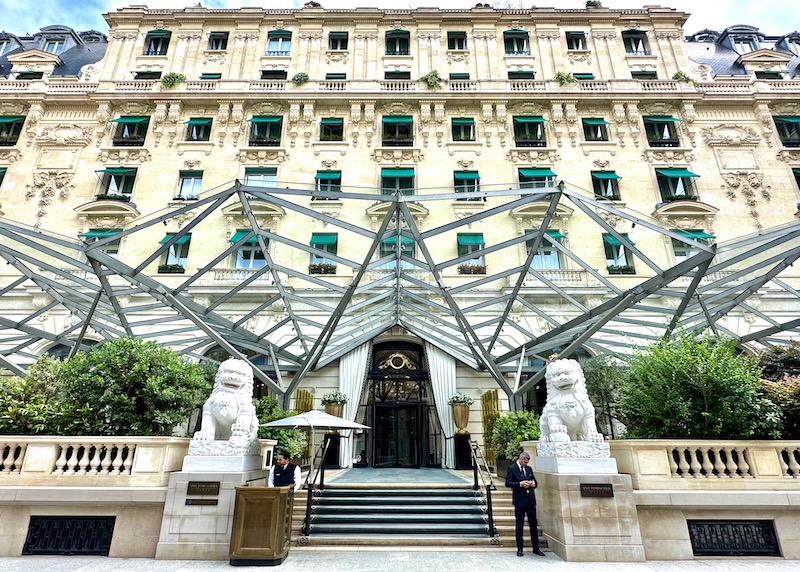 Chinese stone lions at the entrance of The Peninsula under a geometric canopy in Paris