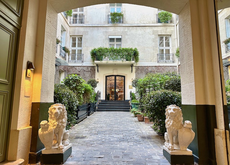Lions at the entrance to the courtyard of Relais Christine hotel in Paris