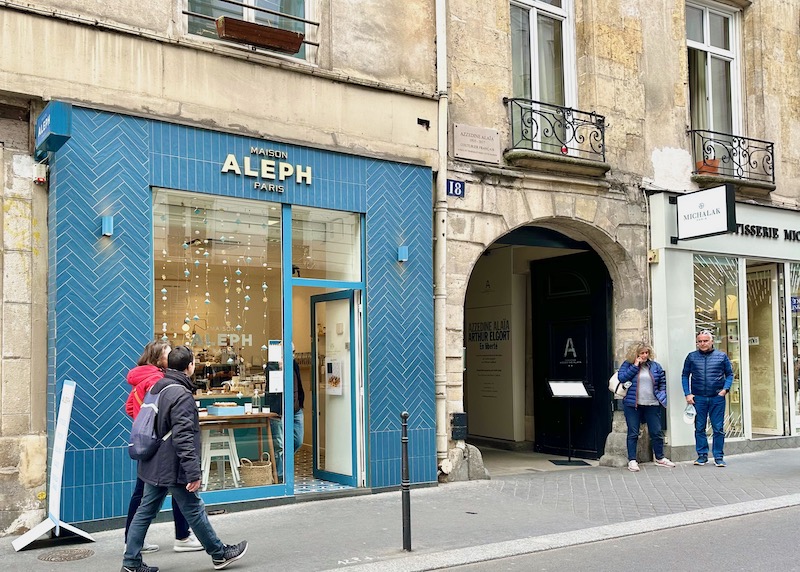 Exterior of Maison Aleph patisserie in blue tiles with gold lettering in Paris