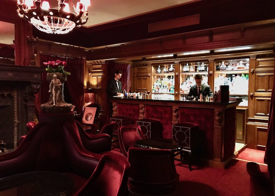The bar at Maison Souquet in Paris, decked out in plush red velvet