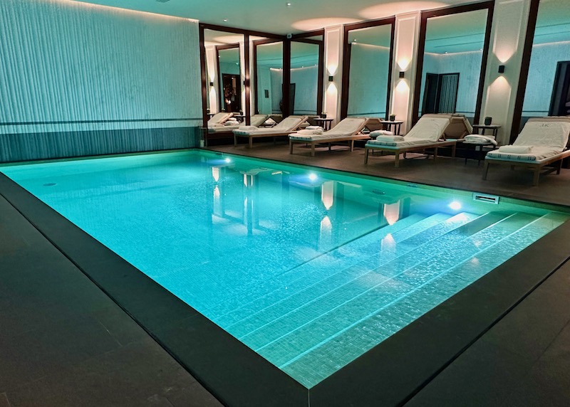 The spa pool with a row of lounge chairs at JK Place in the 7th Arrondissement of Paris