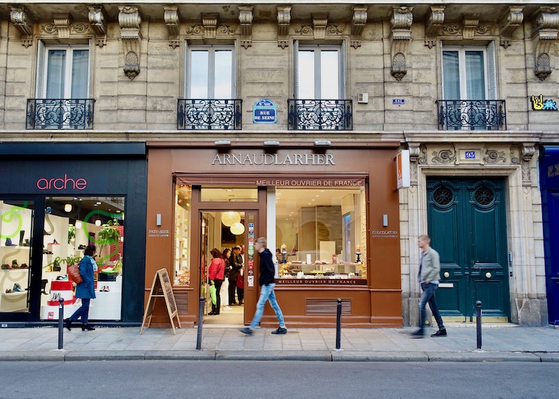 Exterior of Arnaud Larher patisserie and chocolatier on the ground floor of a Haussmann building in Paris