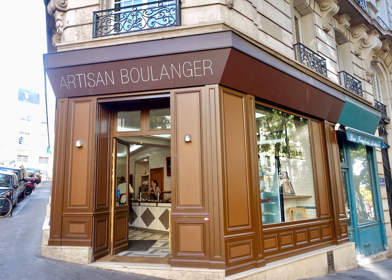 Exterior of Gontran Cherrier bakery at the base of a Haussmann-style building in Paris