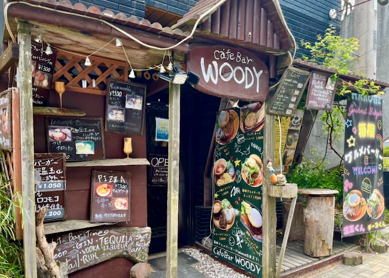 A western front cafe with brown wood and food signs.