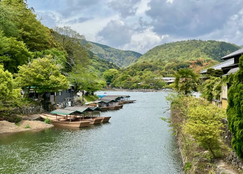 Boats sit parked on the rive in the valley of the mountains.
