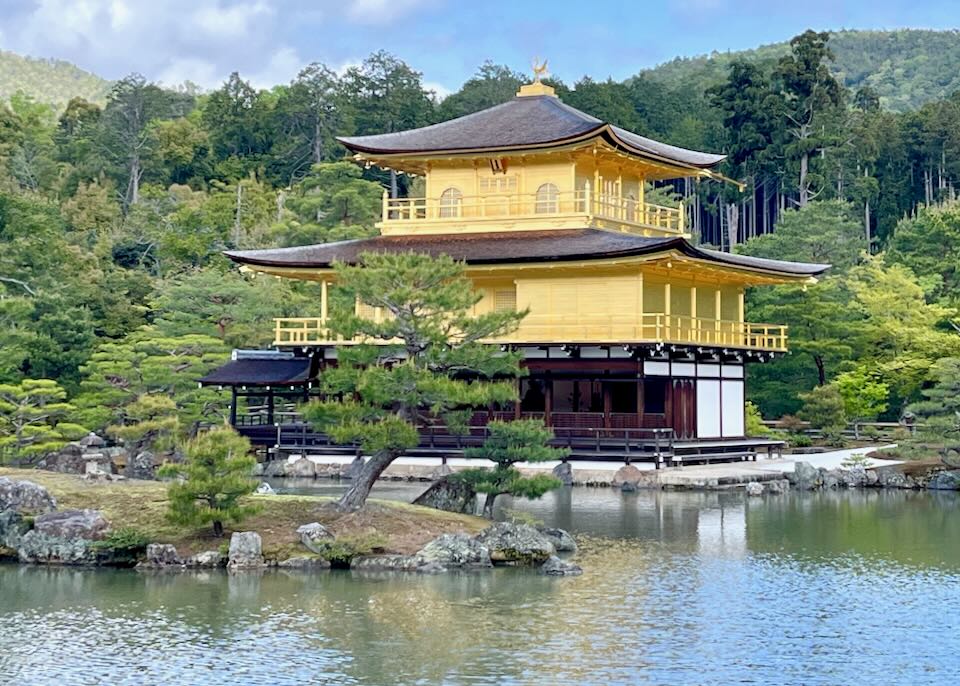 The yellow Kinkaku-ji temple sits on a lake in Kyoto, Japan.