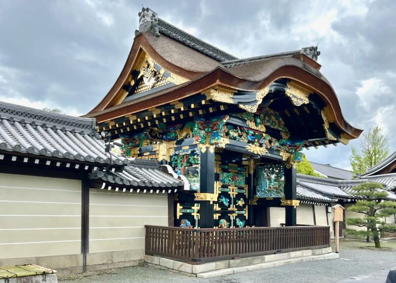 Black, green, blue, and gold leaf cover the wood-carved Temple.