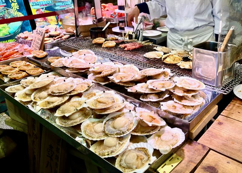 Scallops sit on shells for sale at a food market in Kyoto, Japan.
