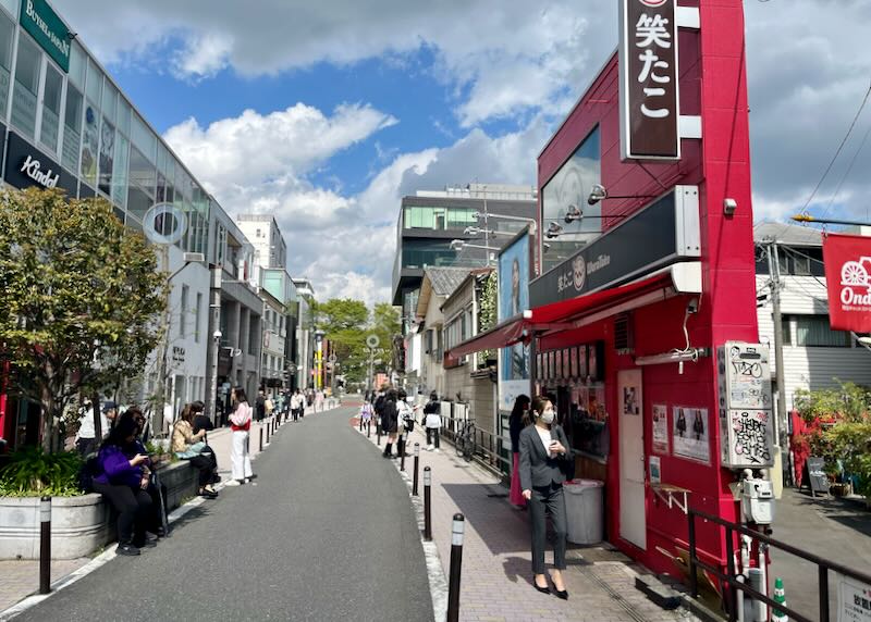 Narrow, modern pedestrian street lined with shops