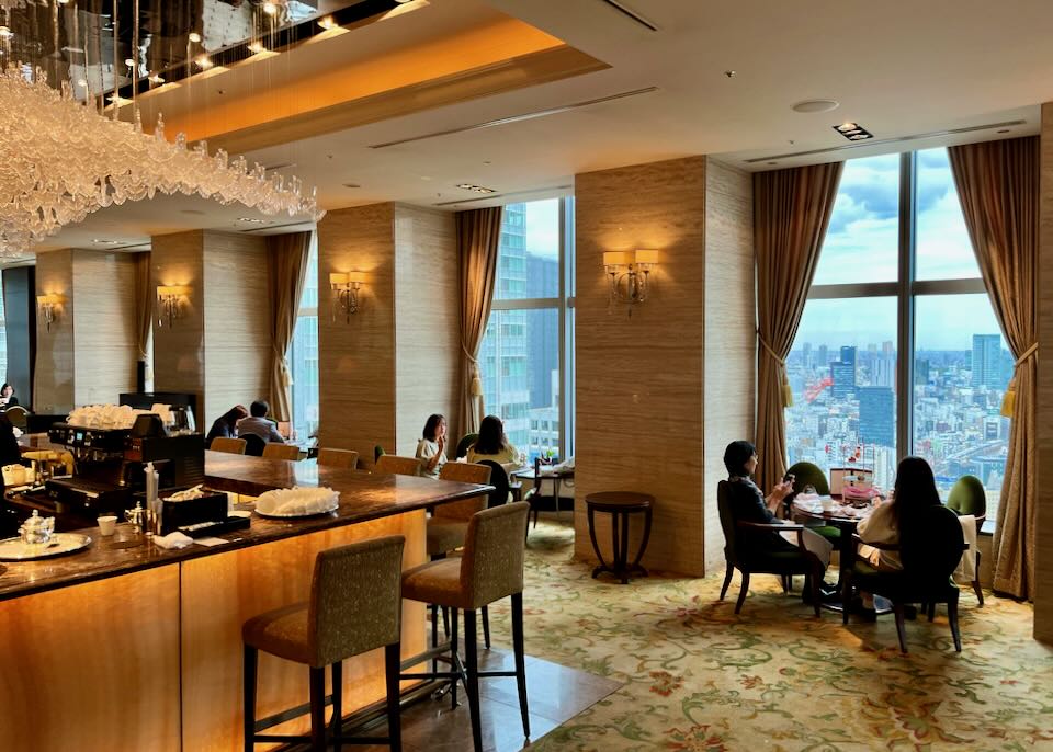Elegant, dimluy-lit bar with sweeping views of Tokyo from floor length windows 