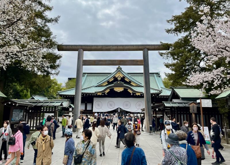 Busy entrance to a Japanese shrine, on a cloudy day