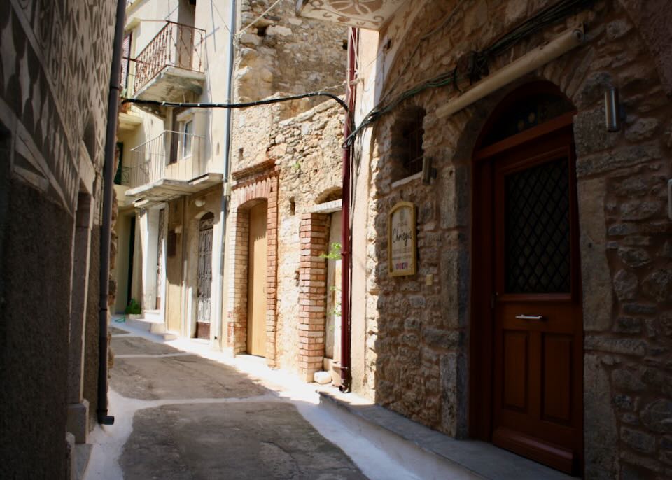 Narrow stone alley with wooden doorways