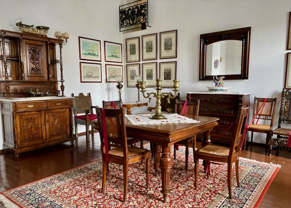 elegant, old-world dining room with ornate wood furnishings and candelabra