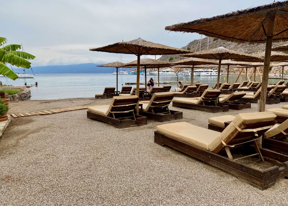 Rows of shaded sun beds on a golden sand beach