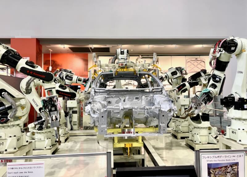A car is being built by robots.