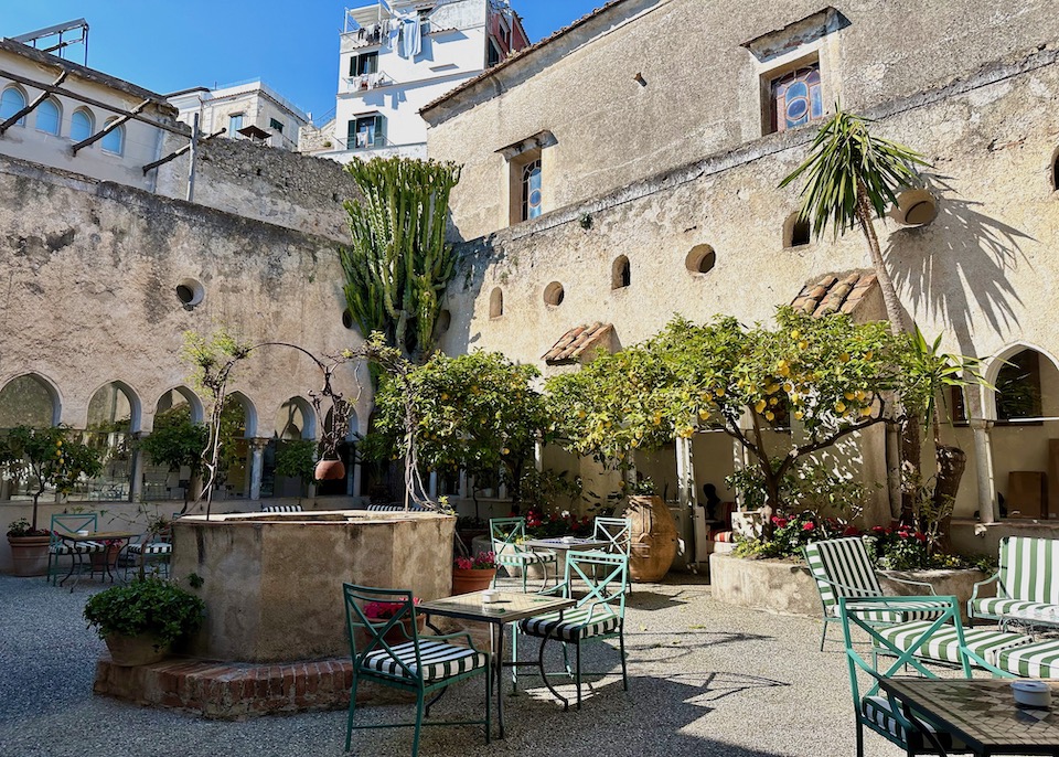 An old well with succulents and lemon trees in the medieval cloister courtyard of Hotel Luna Convento in Amalfi