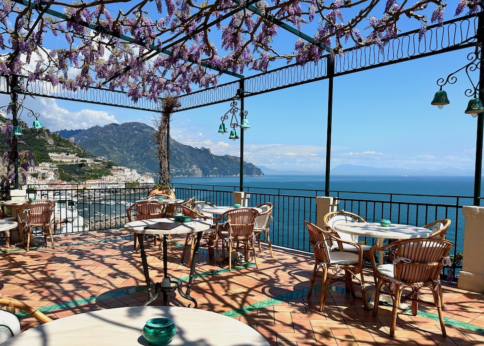 Wisteria hanging from the pergola on the terrace of the lobby bar with a sea view at Santa Caterina Hotel in Amalfi