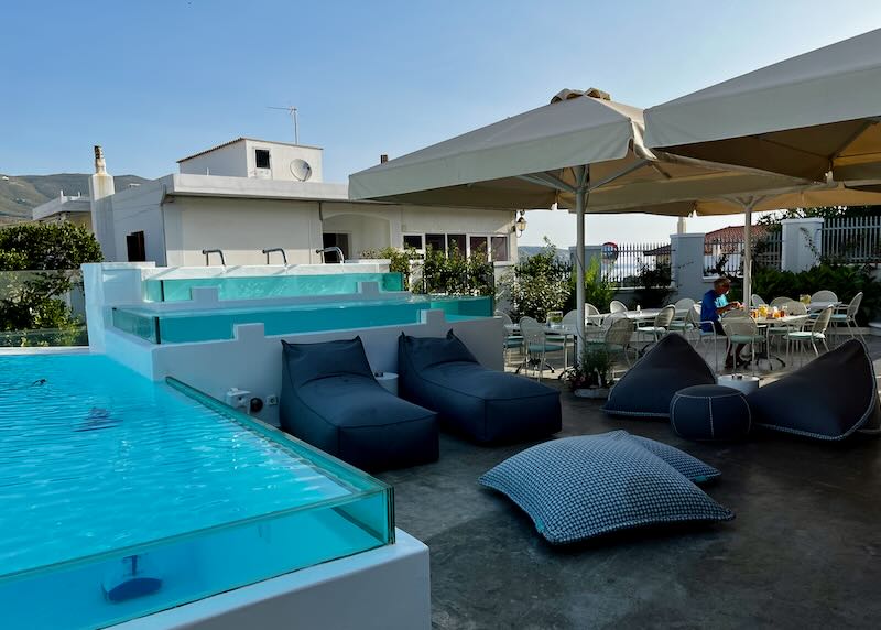 Terrace with glass-sided pools next to sun beds