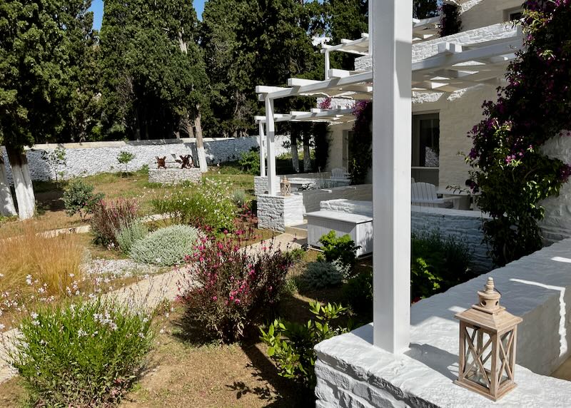 White Aegean-style houses with verandas overlooking a garden