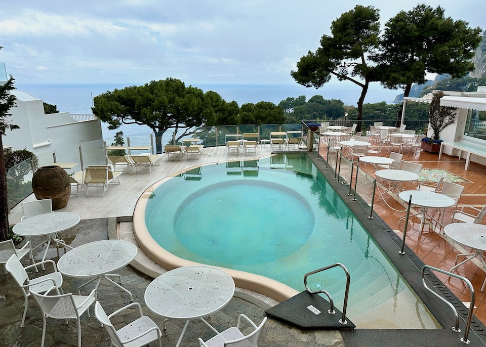Pool with a sun deck and dining terrace overlooking the sea at Casa Morgano in Capri Town