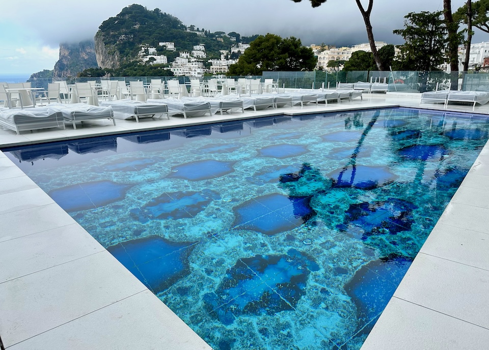 Pool with a custom patterned floor and sea-view terrace at Hotel Scalinatella in Capri Town