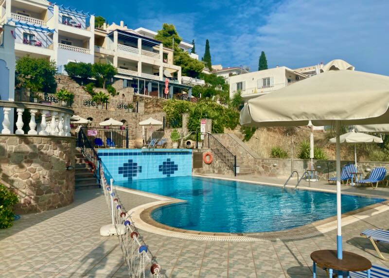 Cream-colored villas surrounding a central pool terrace
