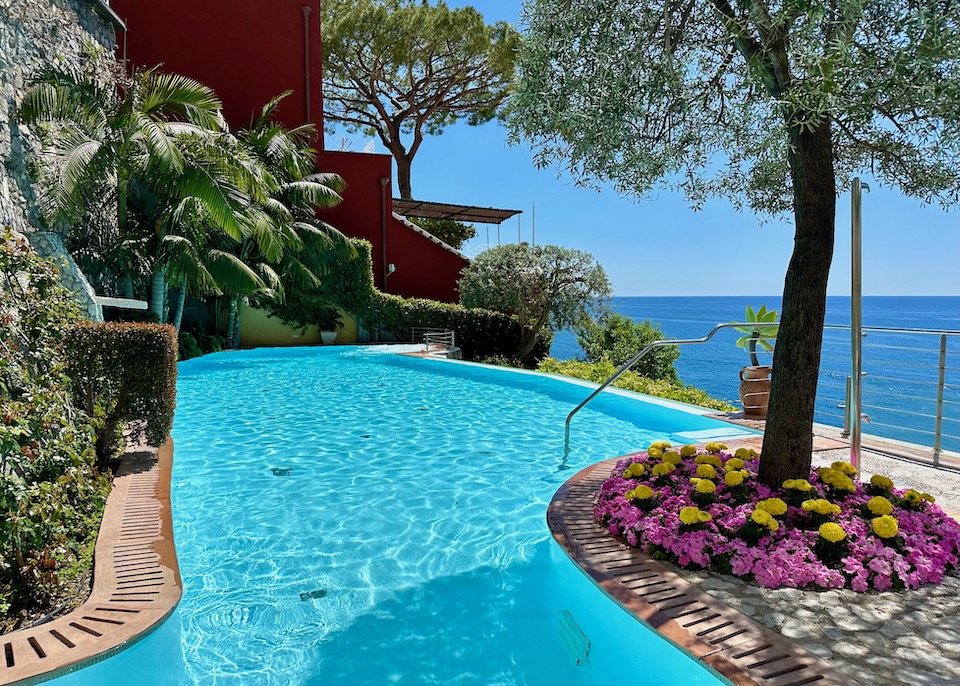 A freeform infinity pool in a garden facing the sea at Hotel Marincanto in Positano on the Amalfi Coast