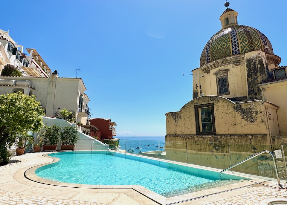 The infinity pool of Palazzo Murat nestled behind the landmark cathedral and facing the sea in Positano on the Amalfi Coast
