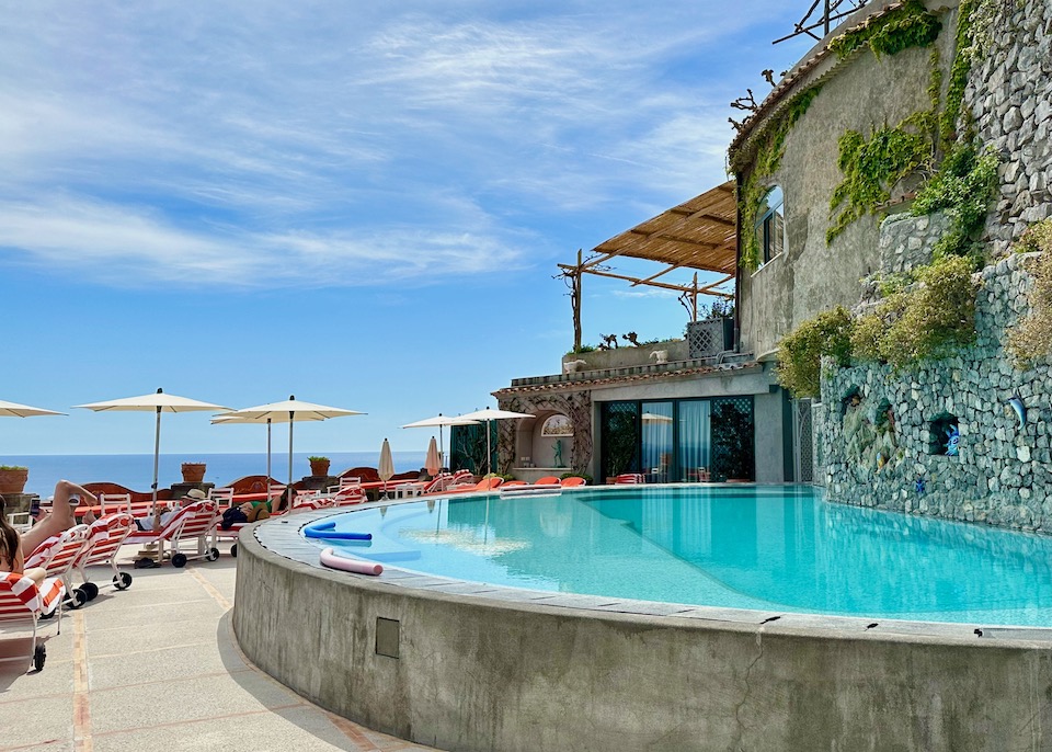 A half-moon infinity pool on the sun terrace at Il San Pietro di Positano on the Amalfi Coast