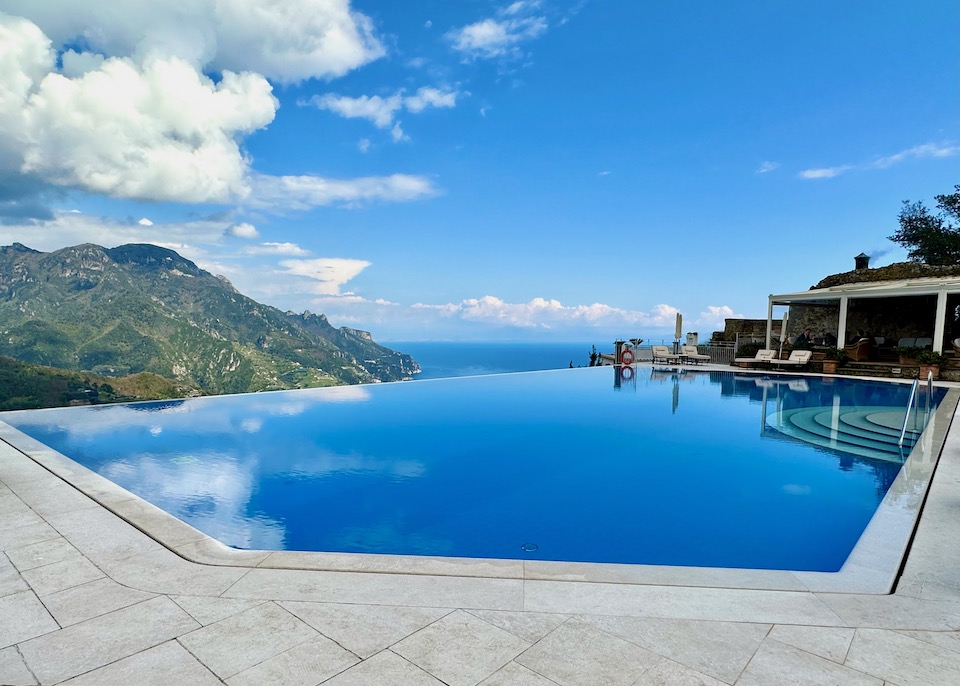 Infinity pool reflecting the sky and clouds and facing the sea at Caruso hotel in Ravello on the Amalfi Coast