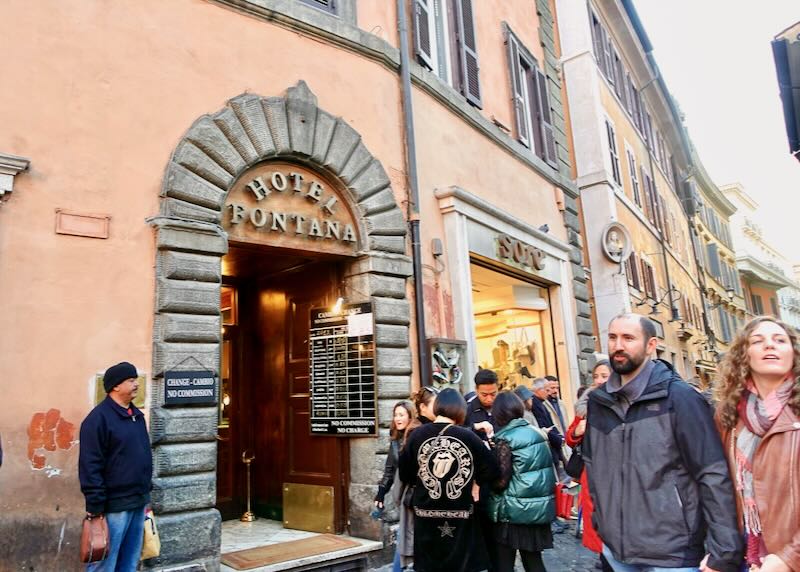 Hotel doorway on a bustling street in Rome