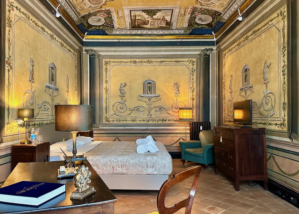 Elaborate frescoed walls and ceilings in Camera Quattro at Casa Santangelo in Centro Storico in Salerno