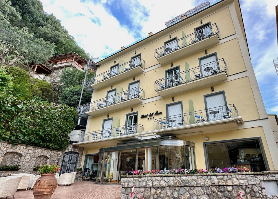 Yellow exterior with balconies and a glass entryway at Hotel del Mare in Sorrento