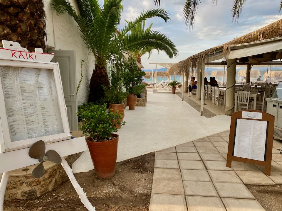 Entrance to a beach club with bar and shaded sun beds