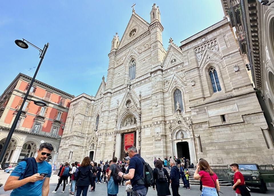 View of the intricately carved, white stone, Gothic facade of the Cathedral of Naples in the Centro Storico